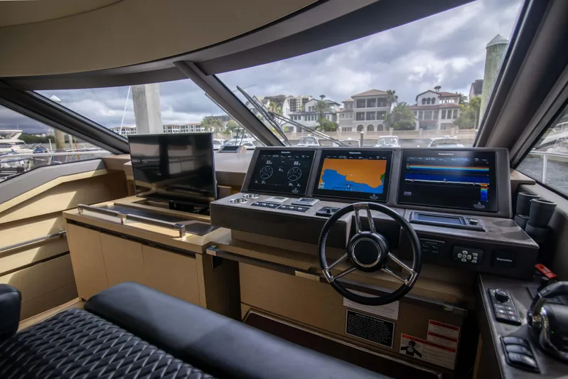 Prestige Worldwide Yacht Photos Pics Prestige 680 Flybridge 2018 yacht helm with navigation screens and steering wheel.