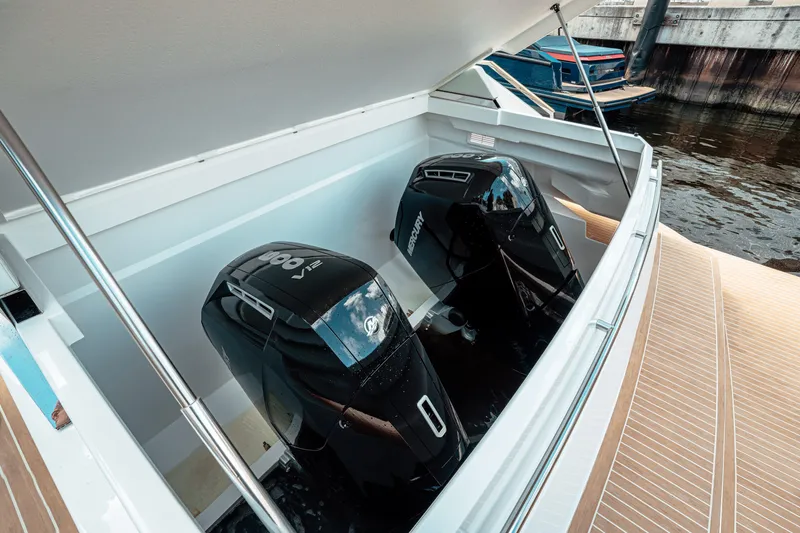  Yacht Photos Pics 2025 De Antonio Yachts D50 Coupé with dual outboard engines, docked in a marina.