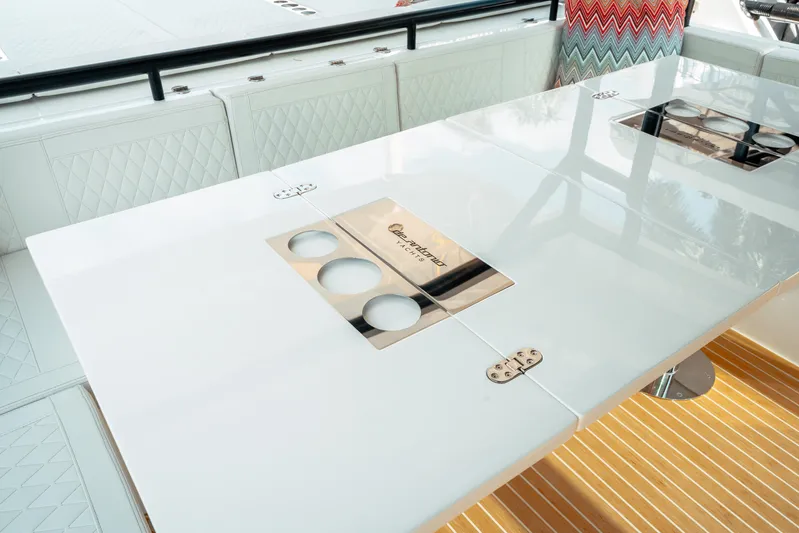  Yacht Photos Pics 2025 De Antonio Yachts D50 Coupé interior with sleek white table and modern design elements.