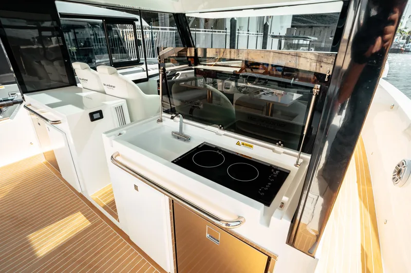  Yacht Photos Pics 2025 De Antonio Yachts D50 Coupé kitchen area with modern appliances and sleek design.