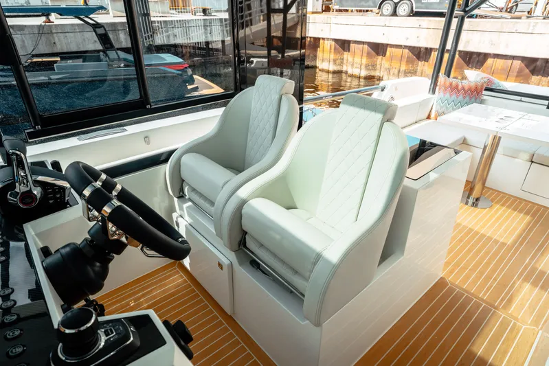  Yacht Photos Pics Luxury interior of 2025 De Antonio Yachts D50 Coupé with elegant seating and modern controls.