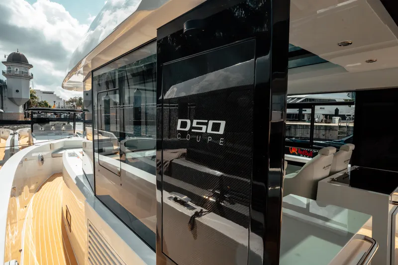  Yacht Photos Pics 2025 De Antonio Yachts D50 Coupé, sleek design with modern features, docked under sunny skies.