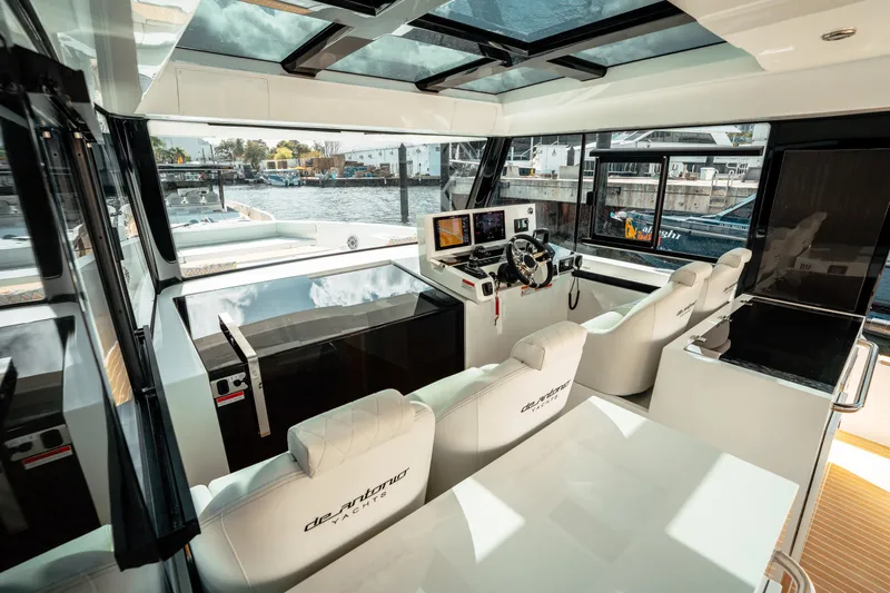  Yacht Photos Pics 2025 De Antonio Yachts D50 Coupé interior with modern helm and luxurious seating.