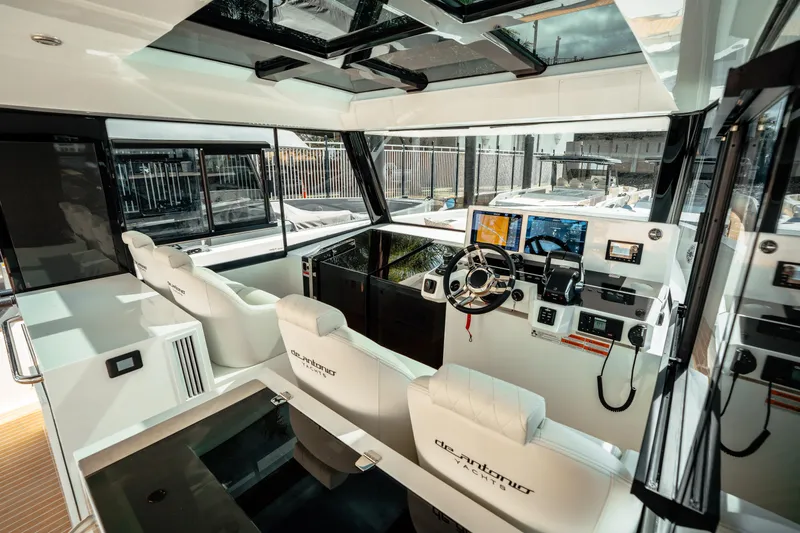  Yacht Photos Pics Interior of 2025 De Antonio Yachts D50 Coupé, featuring modern helm and luxurious seating.