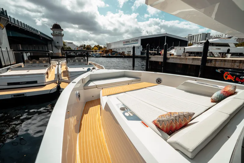  Yacht Photos Pics 2025 De Antonio Yachts D50 Coupé docked, showcasing sleek design and luxurious seating.