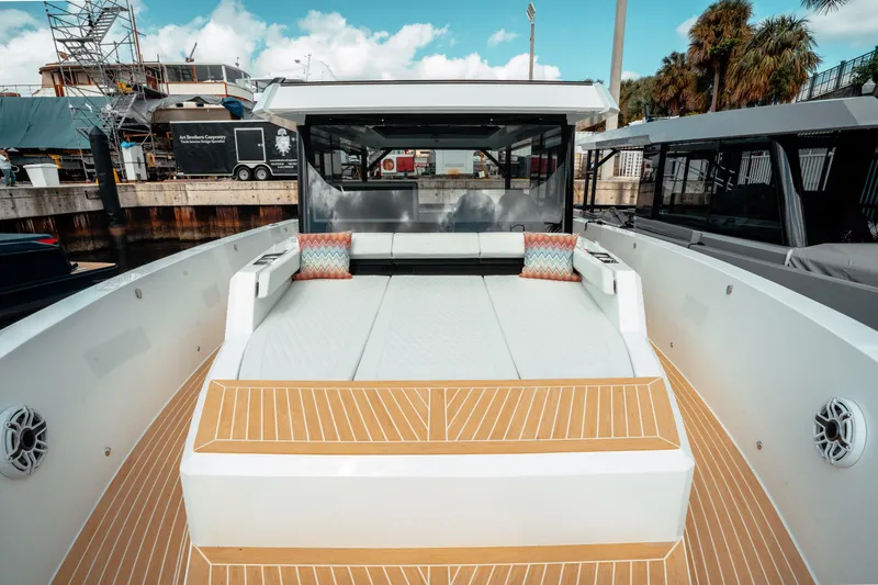  Yacht Photos Pics 2025 De Antonio Yachts D50 Coupé with spacious deck and modern design at a marina.