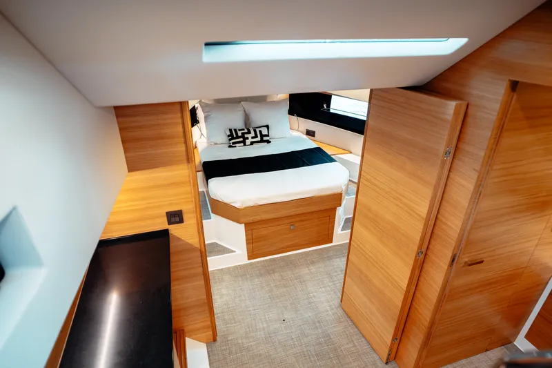  Yacht Photos Pics Luxurious interior of 2025 De Antonio Yachts D50 Coupé with modern wood finish and cozy bed.