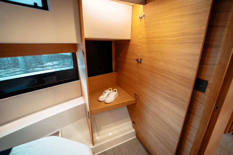  Yacht Photos Pics Interior of 2025 De Antonio Yachts D50 Coupé with wooden closet and shoes.