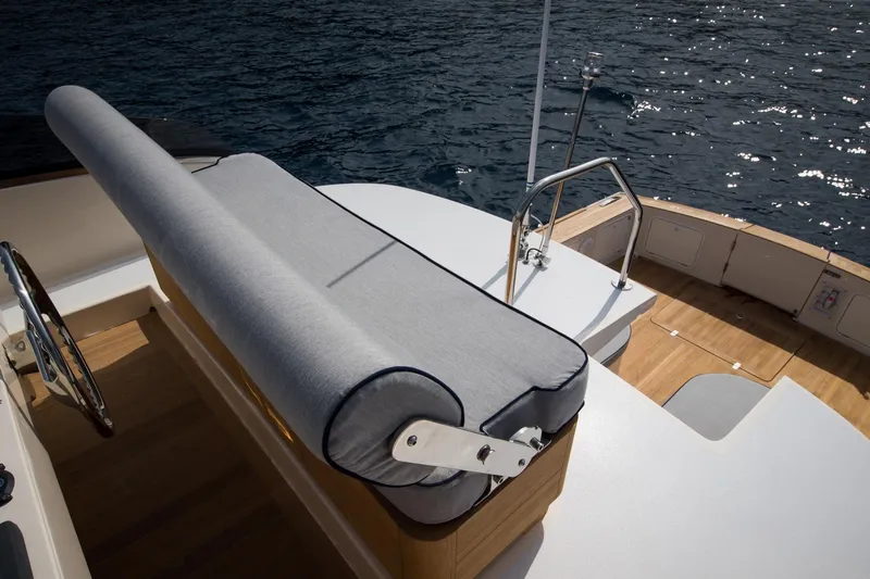 36 Fly Yacht Photos Pics Luxury Toy 36 Fly yacht deck with cushioned seating, 2025 model, overlooking serene water.