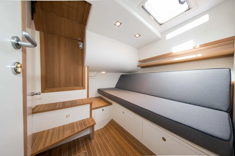 36 Fly Yacht Photos Pics Modern interior of 2025 Toy 36 Fly yacht with wooden steps and cushioned seating.