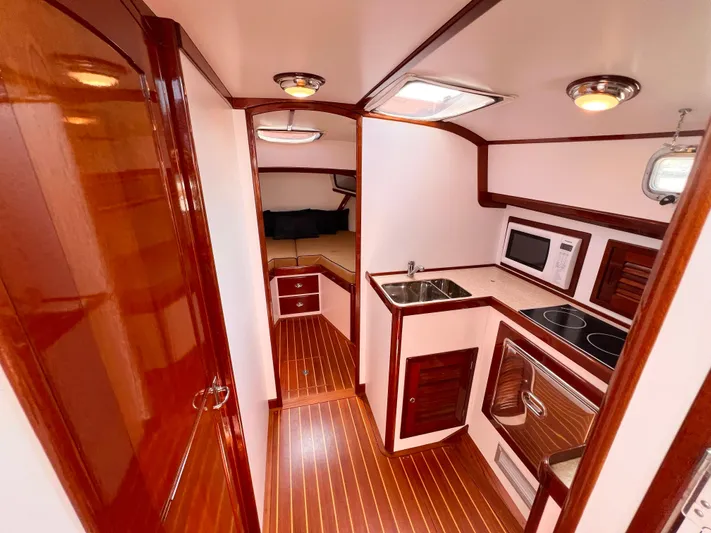 Indigo Yacht Photos Pics Luxurious 2007 Bruckmann 34e yacht interior with modern kitchen and wood finishes.