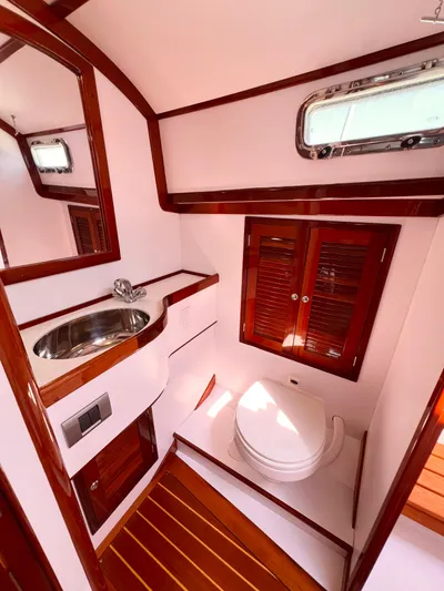 Indigo Yacht Photos Pics Luxurious 2007 Bruckmann 34e yacht bathroom with wood accents and modern fixtures.