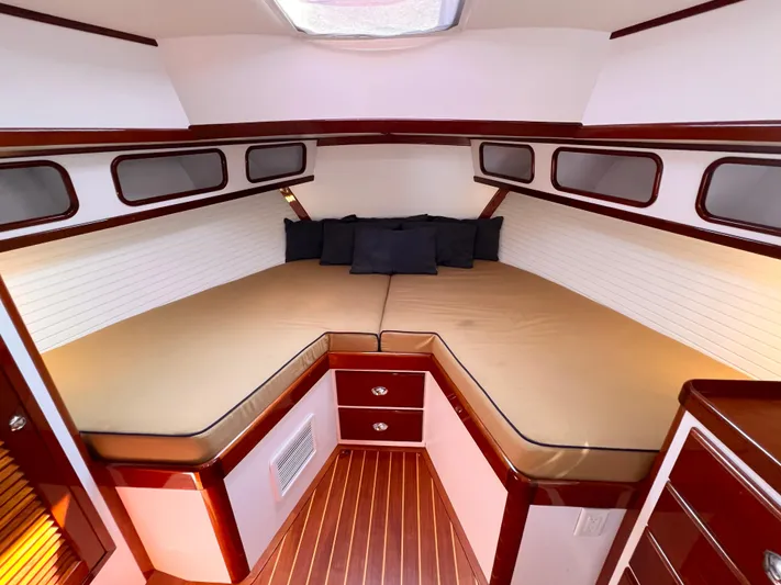 Indigo Yacht Photos Pics Luxurious cabin interior of 2007 Bruckmann 34e yacht with cozy bedding and wood accents.