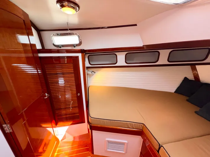 Indigo Yacht Photos Pics Luxurious cabin interior of 2007 Bruckmann 34e yacht with wood finish and cozy bed.