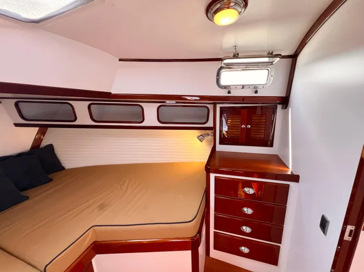 Indigo Yacht Photos Pics Luxurious cabin interior of 2007 Bruckmann 34e yacht with wood finish and cozy bed.