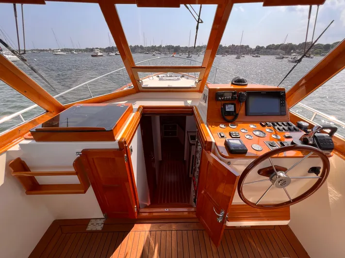 Indigo Yacht Photos Pics 2007 Bruckmann 34e yacht cockpit with wooden interior and navigation equipment.