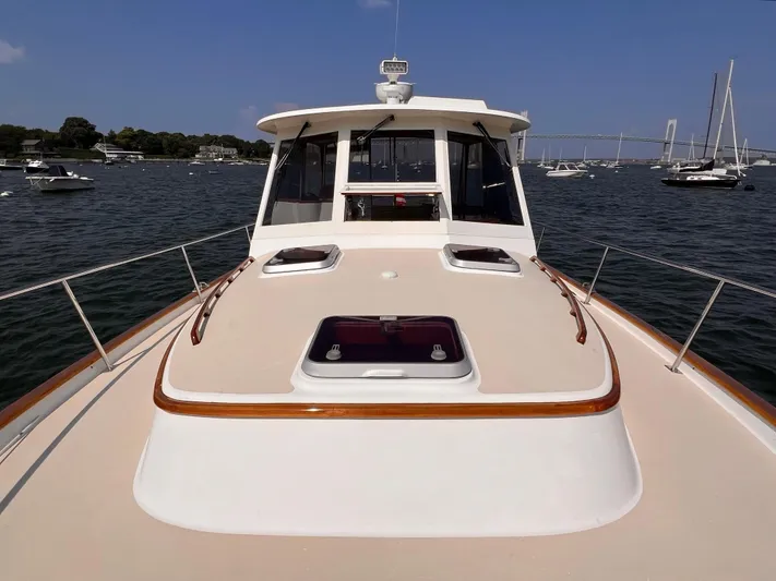 Indigo Yacht Photos Pics 2007 Bruckmann 34e yacht on water with scenic background.