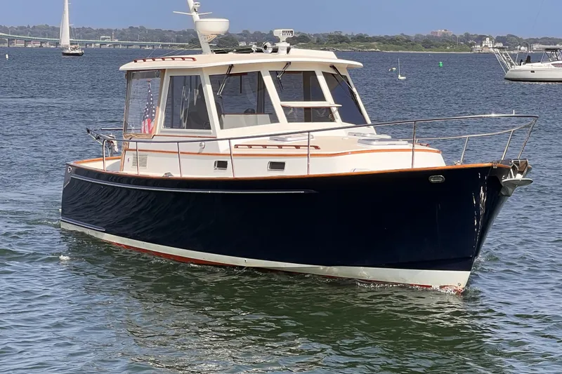 Indigo Yacht Photos Pics 2007 Bruckmann 34e boat cruising on a calm lake.