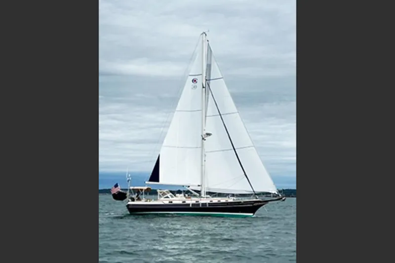 Dreamwalker Yacht Photos Pics Sailing yacht Gozzard 41B, 2008 model, cruising on open water under cloudy skies.