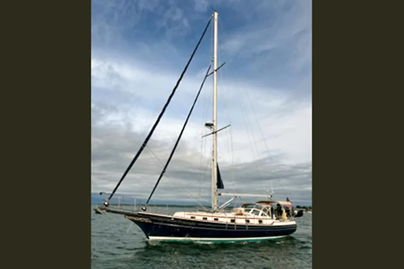 Dreamwalker Yacht Photos Pics 2008 Gozzard 41B sailboat on open water under a cloudy sky.
