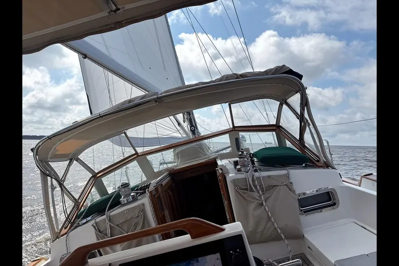 Dreamwalker Yacht Photos Pics Sailing on a 2008 Gozzard 41B yacht with open sails under a partly cloudy sky.