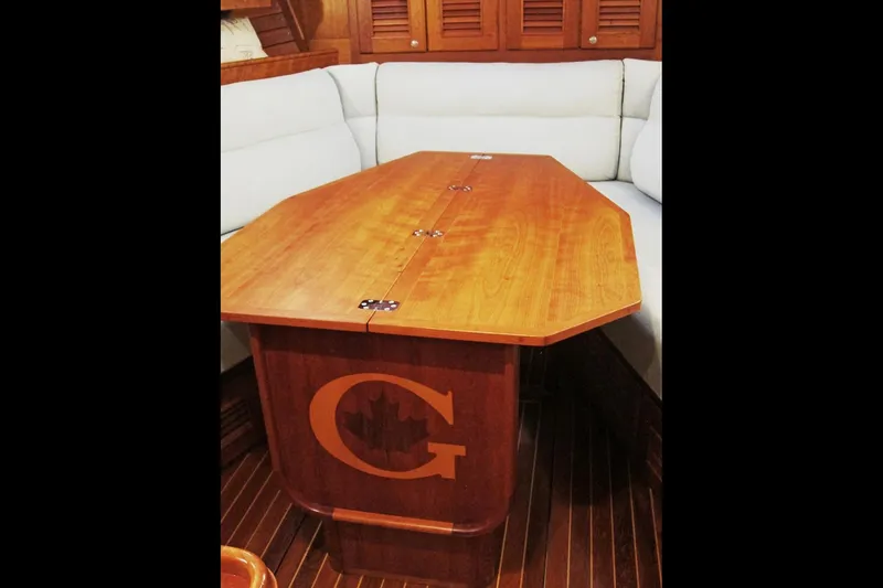 Dreamwalker Yacht Photos Pics Luxurious wooden table in 2008 Gozzard 41B yacht interior, featuring elegant seating.