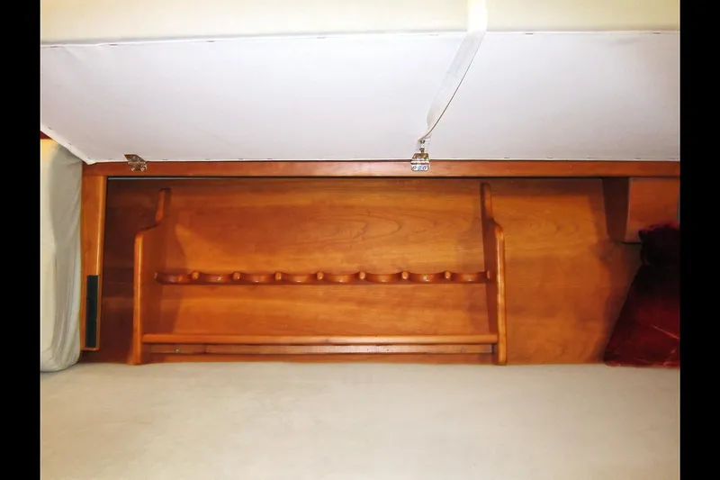 Dreamwalker Yacht Photos Pics Wooden interior storage space in a 2008 Gozzard 41B yacht, featuring a built-in rack.