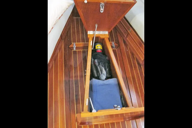 Dreamwalker Yacht Photos Pics Open storage compartment on 2008 Gozzard 41B yacht with wooden flooring.