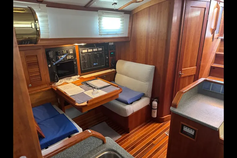 Dreamwalker Yacht Photos Pics 2008 Gozzard 41B yacht interior with navigation station and wooden furnishings.