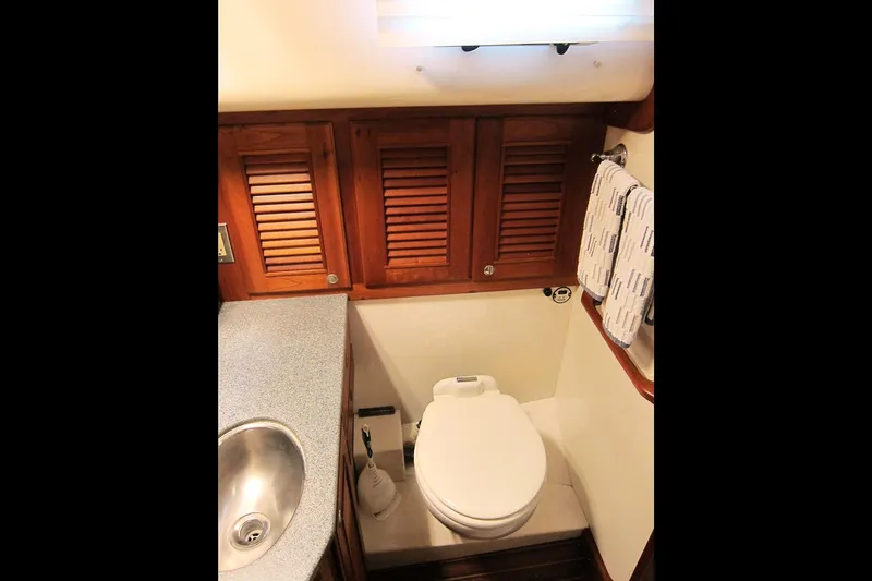 Dreamwalker Yacht Photos Pics Bathroom interior of 2008 Gozzard 41B yacht with wooden cabinets and modern fixtures.