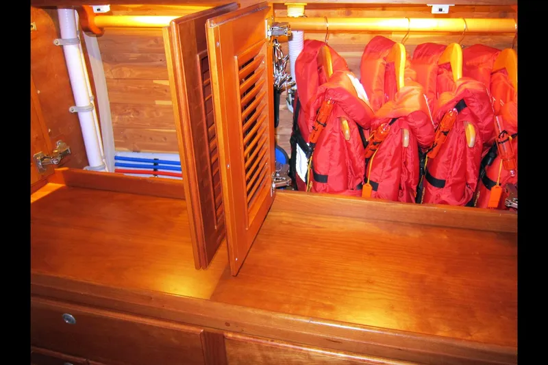 Dreamwalker Yacht Photos Pics Wooden interior of 2008 Gozzard 41B yacht with life jackets in storage.