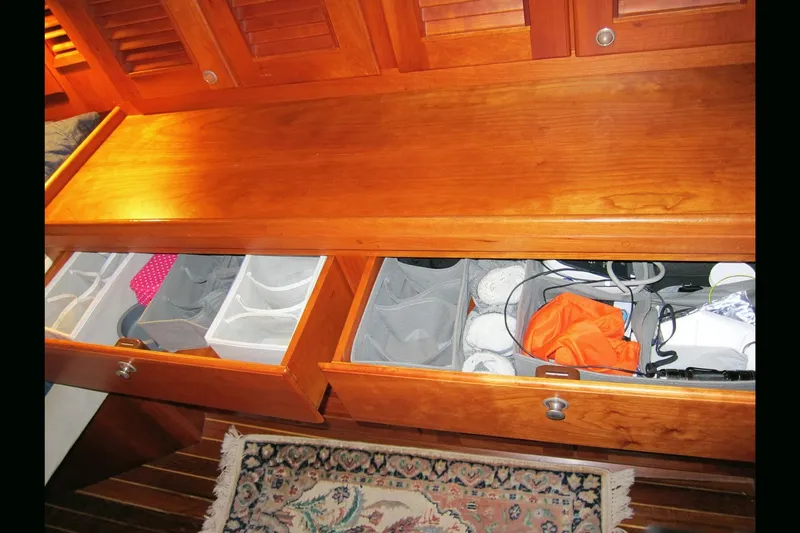 Dreamwalker Yacht Photos Pics Wooden drawers with organized compartments inside a 2008 Gozzard 41B yacht interior.
