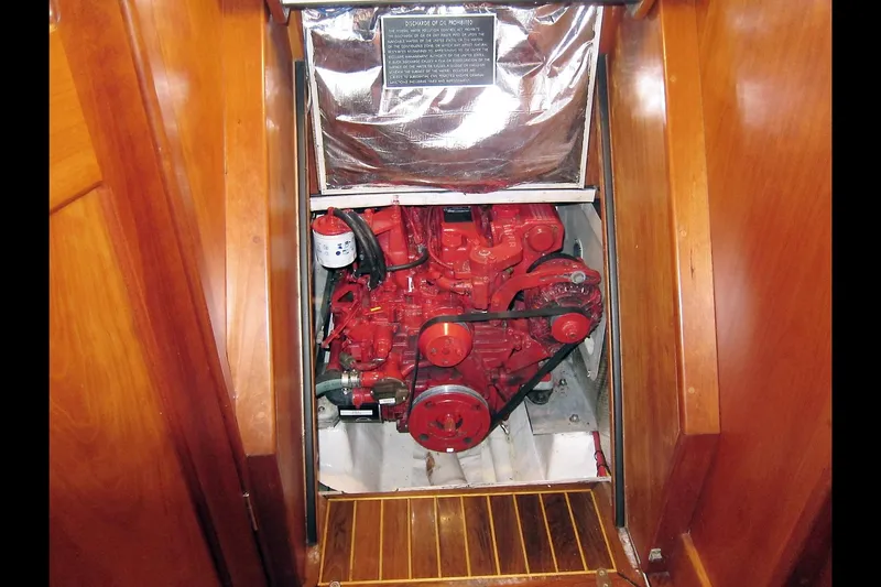 Dreamwalker Yacht Photos Pics Engine compartment of 2008 Gozzard 41B sailboat, featuring a red marine engine.