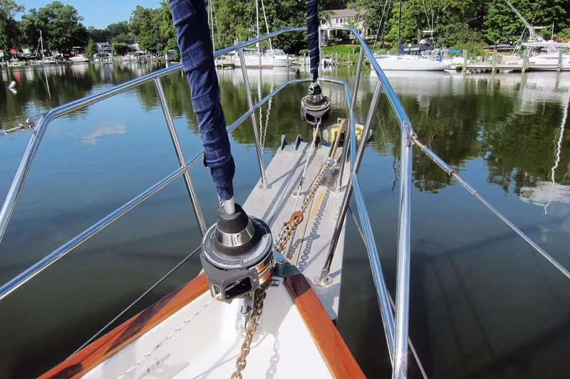 Dreamwalker Yacht Photos Pics Bow view of 2008 Gozzard 41B sailboat docked on calm water.