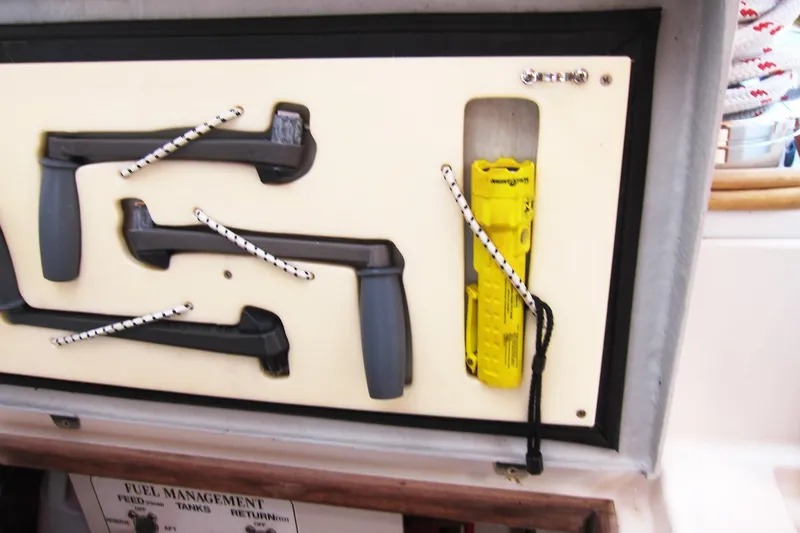 Dreamwalker Yacht Photos Pics Storage panel on a 2008 Gozzard 41B yacht with tools and safety equipment.