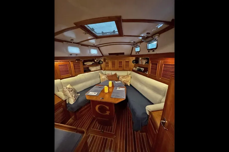 Dreamwalker Yacht Photos Pics Luxurious interior of 2008 Gozzard 41B yacht with elegant wood finish and cozy seating.