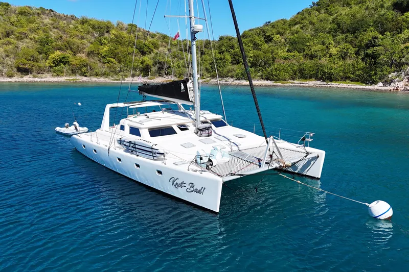 Knot Bad! Yacht Photos Pics 2008 Voyage Yachts 500 catamaran anchored in clear blue water near lush green shoreline.