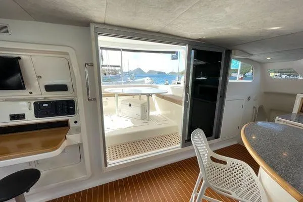 Knot Bad! Yacht Photos Pics Interior of 2008 Voyage Yachts 500, featuring modern design and ocean view through sliding door.