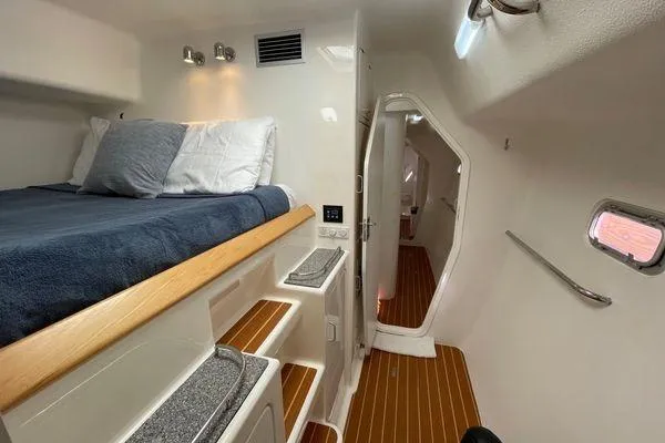 Knot Bad! Yacht Photos Pics Cozy cabin interior of 2008 Voyage Yachts 500 with bed, wooden flooring, and modern amenities.