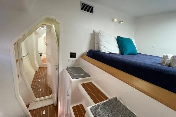 Knot Bad! Yacht Photos Pics Interior of 2008 Voyage Yachts 500, featuring cozy cabin with bed and wooden flooring.