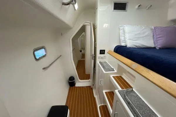 Knot Bad! Yacht Photos Pics Interior of 2008 Voyage Yachts 500, featuring cozy cabin with bed and wooden flooring.