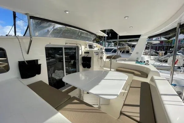 Knot Bad! Yacht Photos Pics Spacious deck of 2008 Voyage Yachts 500 with seating and table, docked at marina.