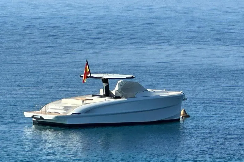 Esimar Yacht Photos Pics 2023 Solaris Power 40 Open yacht anchored on calm blue water.