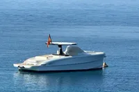2023 Solaris Power 40 Open yacht anchored on calm blue water.