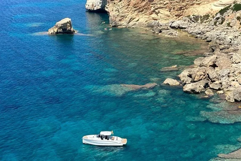 Esimar Yacht Photos Pics 2023 Solaris Power 40 Open yacht in clear blue coastal waters.