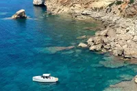 2023 Solaris Power 40 Open yacht in clear blue coastal waters.