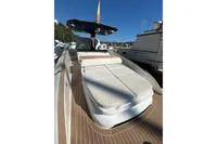 2023 Solaris Power 40 Open yacht with sunbed, docked in marina under clear blue sky.