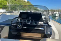 2023 Solaris Power 40 Open boat dashboard with steering wheel and controls at marina.