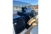 Helm of 2023 Solaris Power 40 Open yacht with sleek black dashboard and steering wheel.