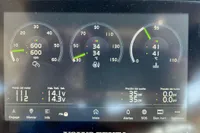 Dashboard of 2023 Solaris Power 40 Open showing engine metrics and battery voltage.